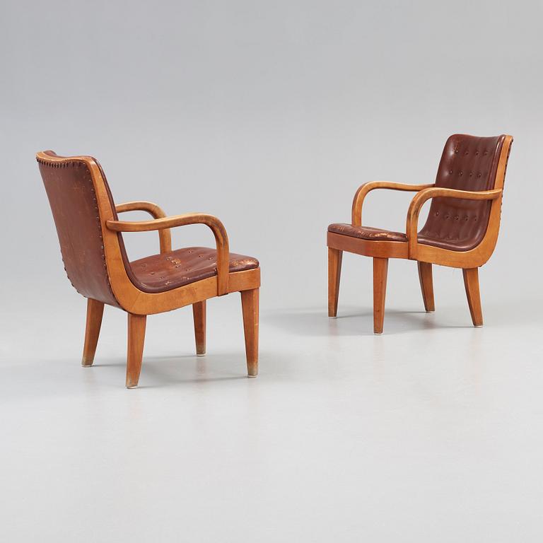 A pair of Swedish Modern birch and brown leather armchairs, probably by Axel Larsson, Bodafors, 1930's.