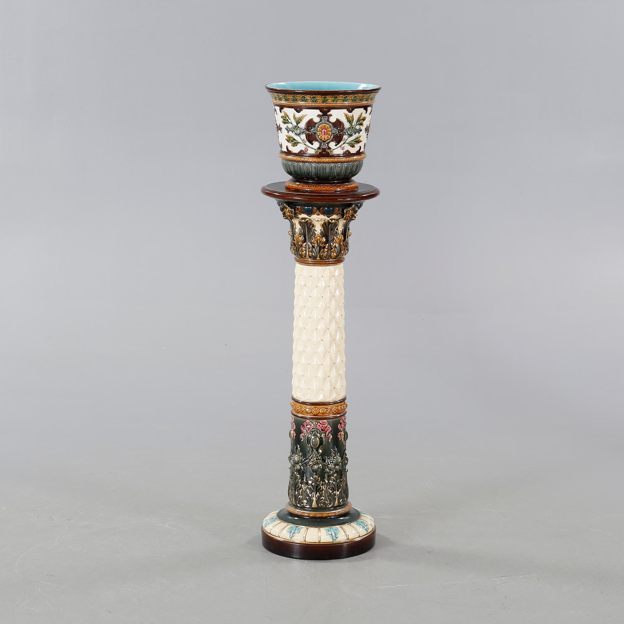 A Rörstrand pedestal with pot in majolica, made around year 1900.