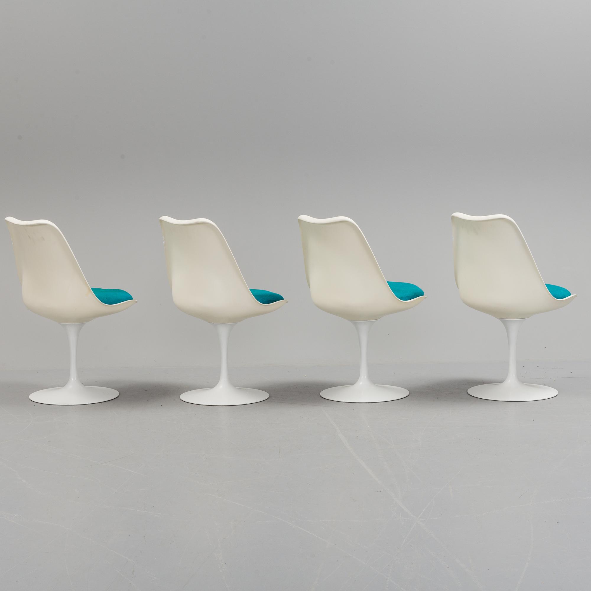 A "Tulip" table and four chairs by Eero Saarinen for Knoll International.