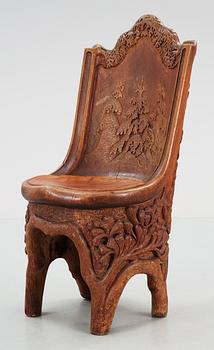 A Gustaf Fjaestad Art Nouveau sculptured pine chair, Sweden circa 1900.
