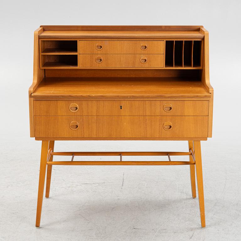 A teak-veneered desk, mid 20th century.