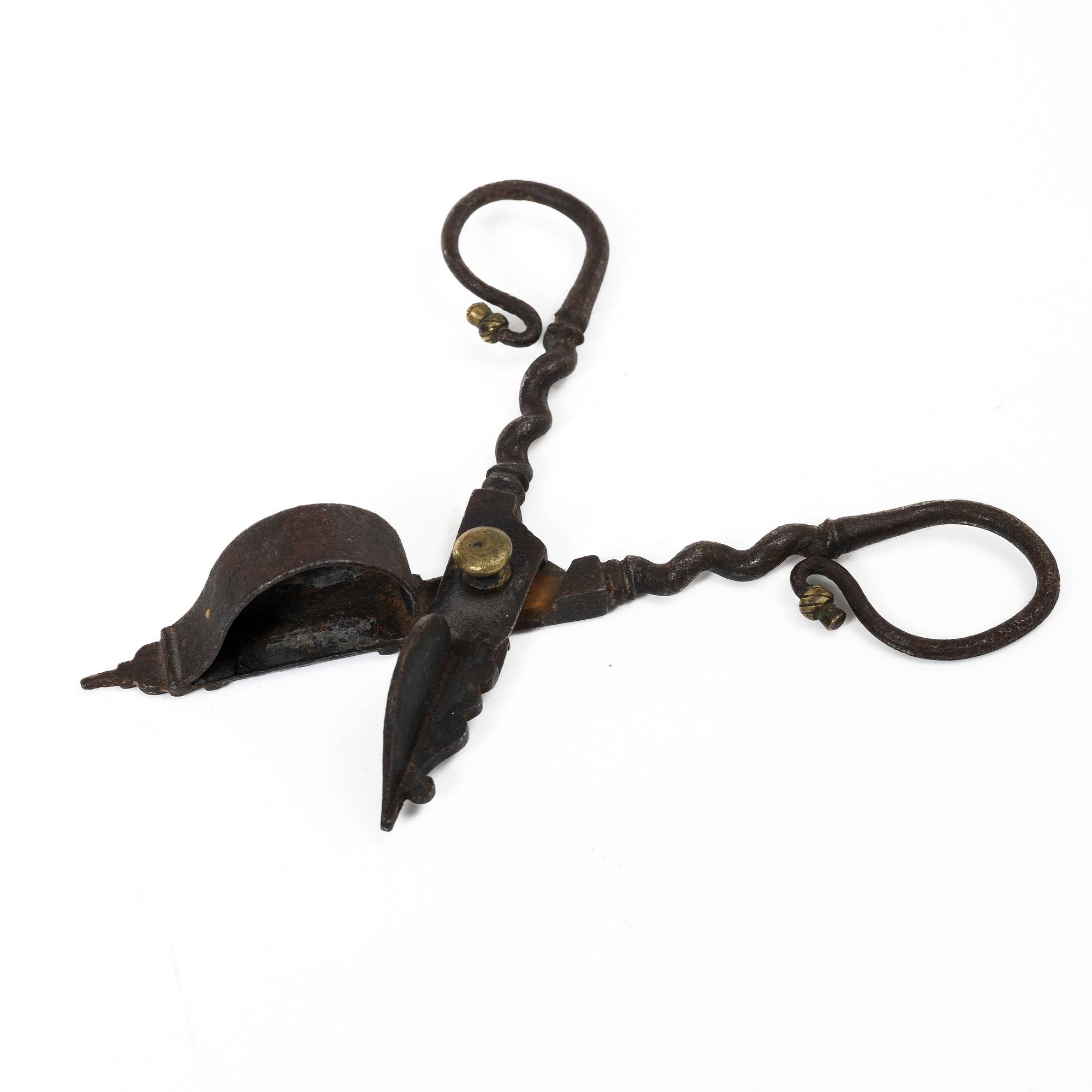 A set of a wrought iron key and wick snuffer, 17th - 18th century.