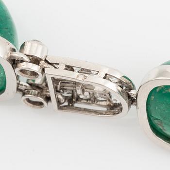 An art deco platinum necklace/bracelet combination with cabochon-cut emeralds.