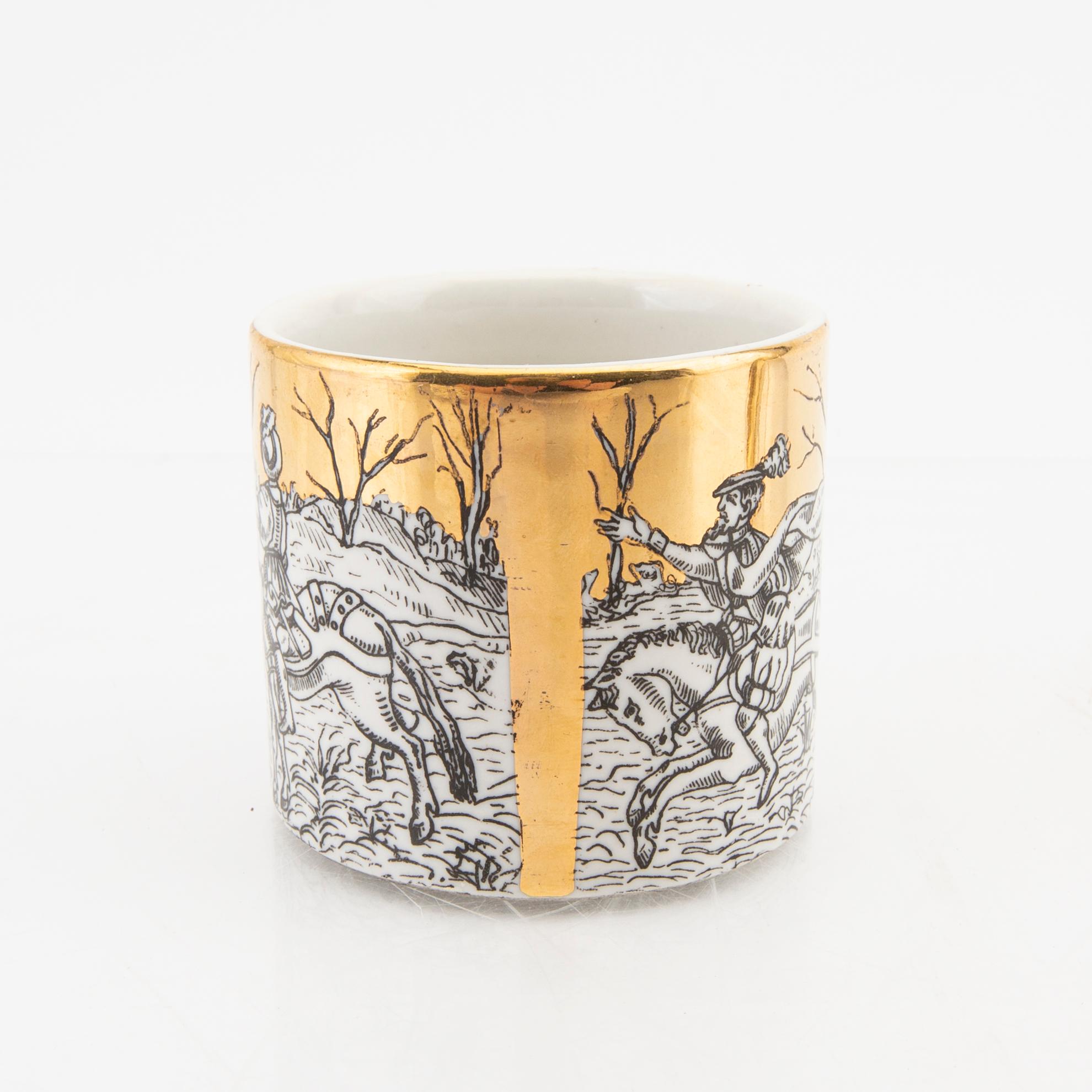 Piero Fornasetti, a set of eight small plates and a mug Italy mid 1900s.