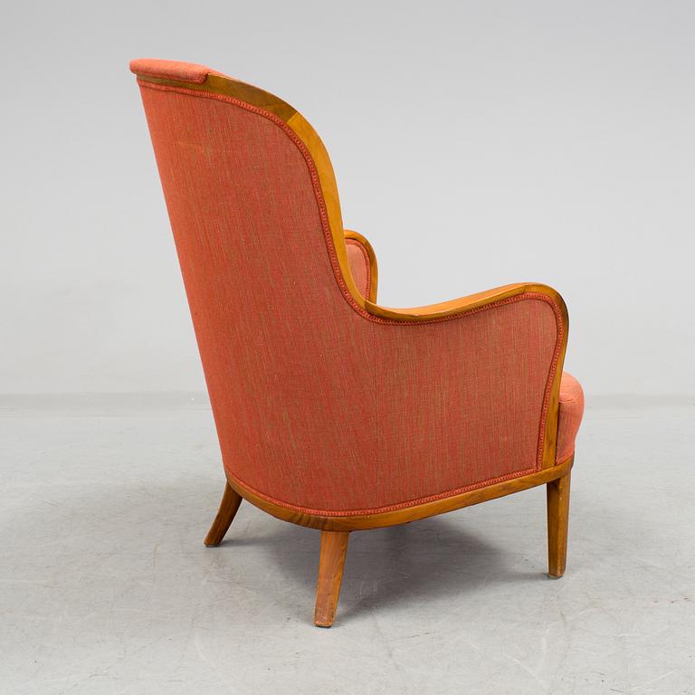 a 20h Century walnut armchair "Advokaten" designed by Carl Malmsten.