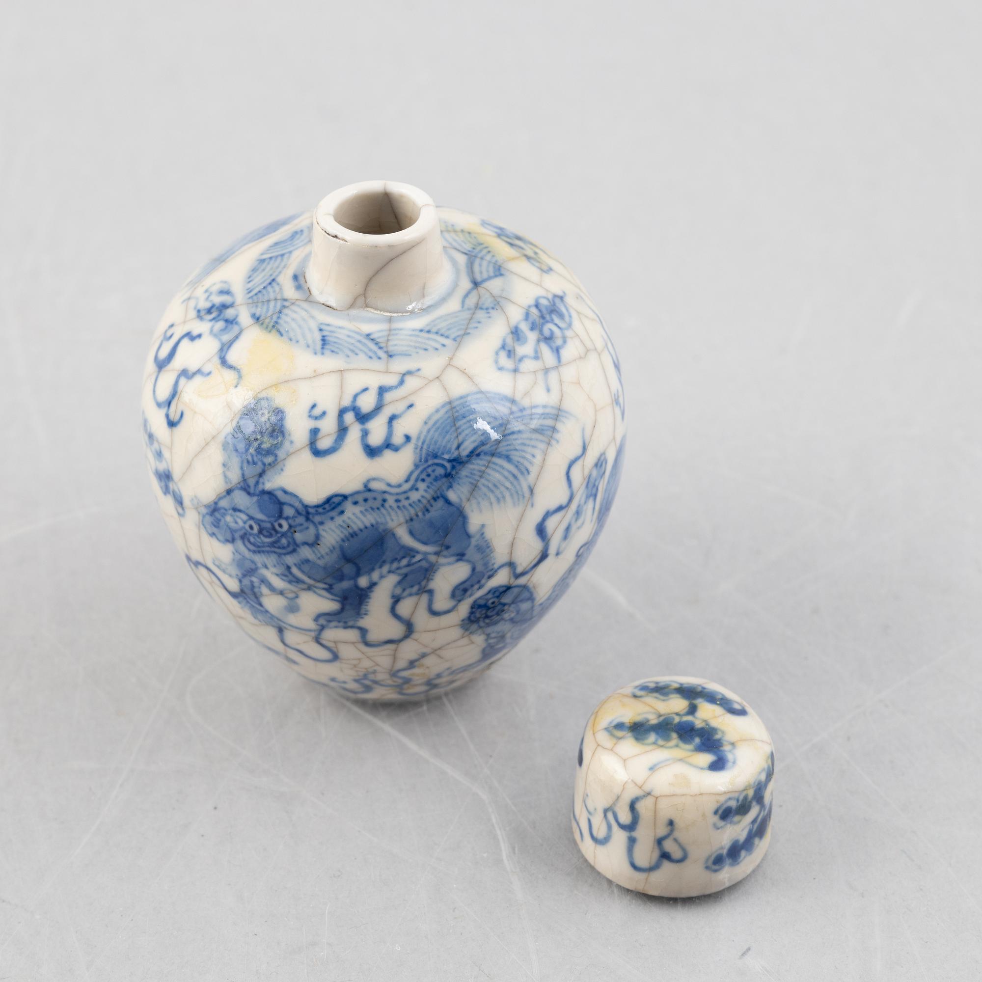 A Chinese bronze tripod censer and two miniature porcelain urns, late Qing dynasty/around 1900.