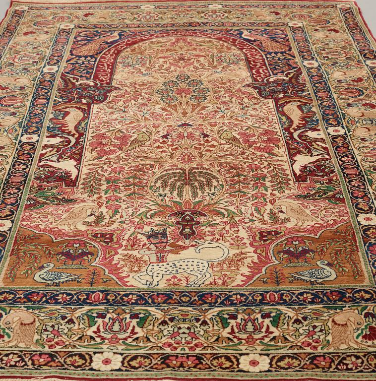 A RUG, an antique/semi-antique Kerman Laver  figural, ca 232,5 x 139,5 cm.