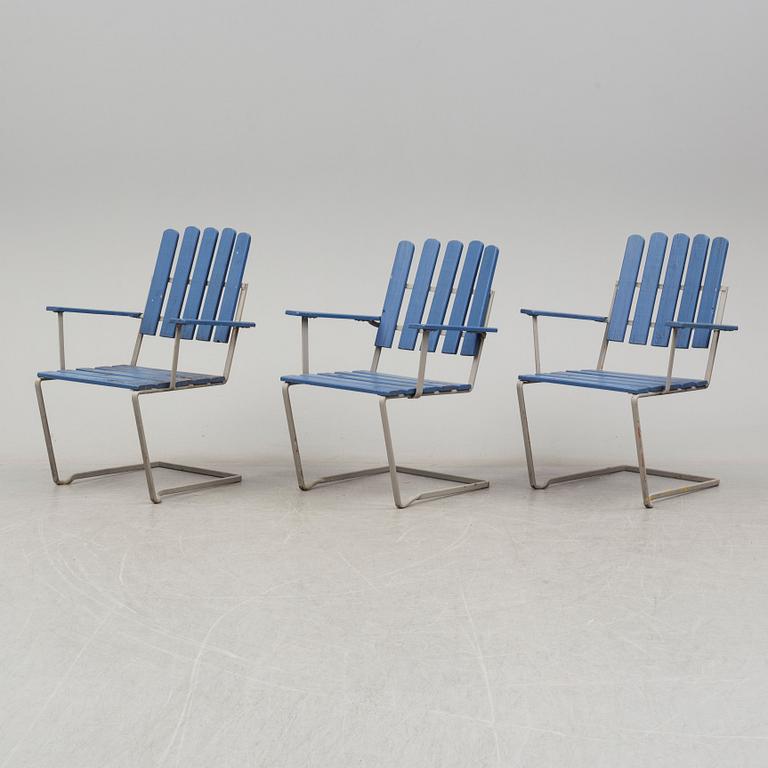 A painted garden table and four armchairs, first half of the 20th century.