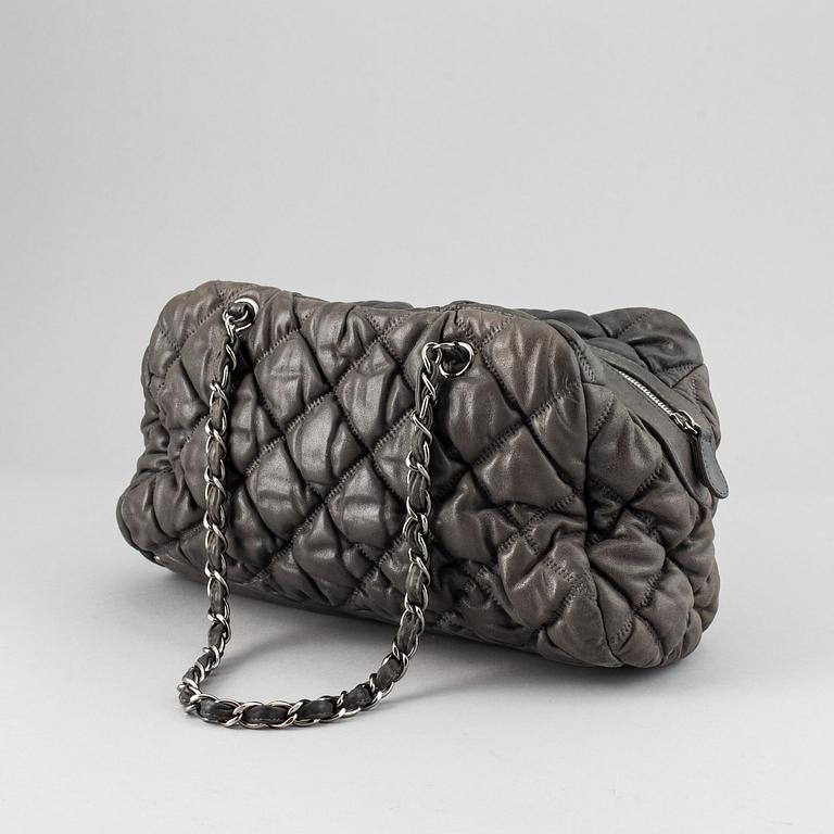 Chanel, a grey leather bag.