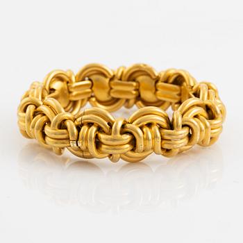 An 18K gold bracelet.