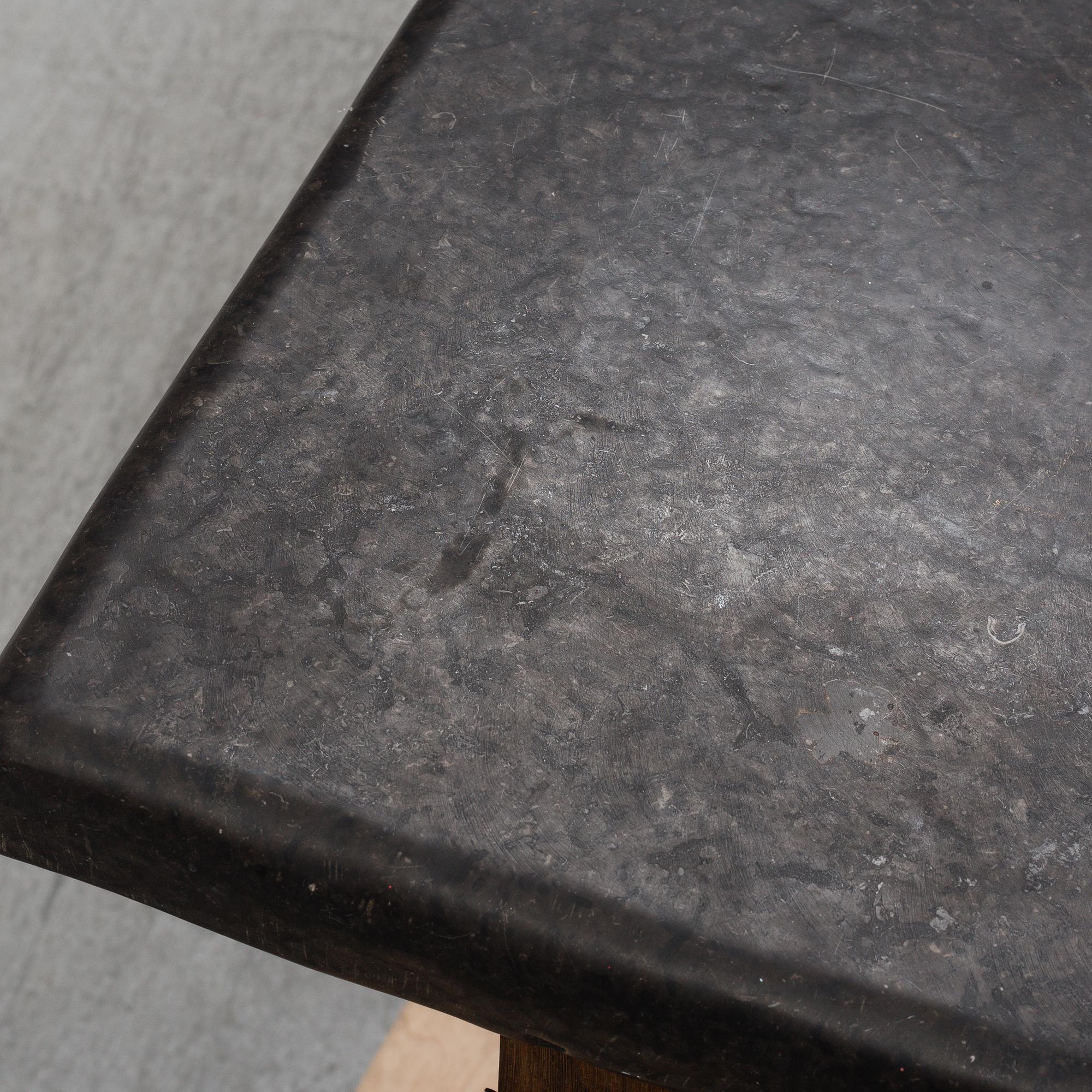 A 19th Century Baroque style table with a stone top.