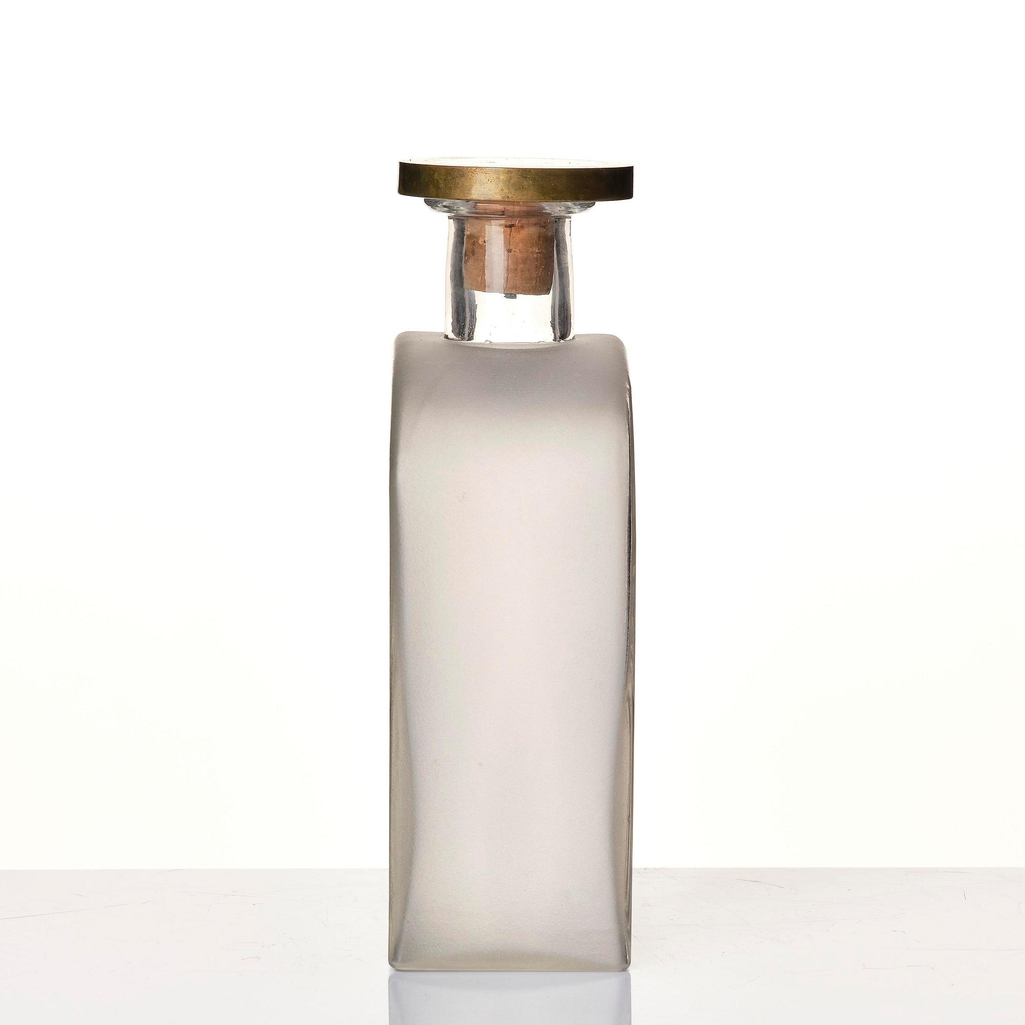 Firma Svenskt Tenn, a glass bottle model A 1608, with a pewter and brass stopper by Björn Trägårdh, Stockholm, 1930s.