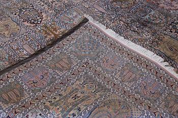A Kashmir silk carpet, 418 x 297 cm.
