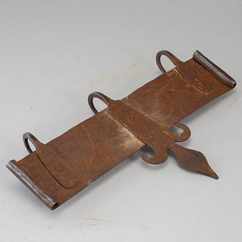 An iron wall hanger, dated 1809.