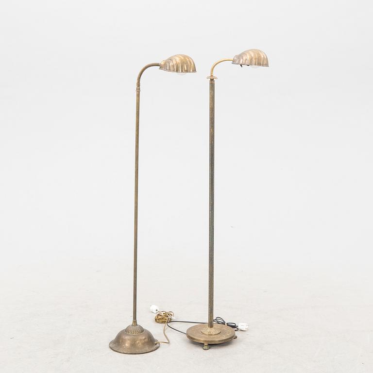 A set of two brass floor lamps later part of the 20th century.