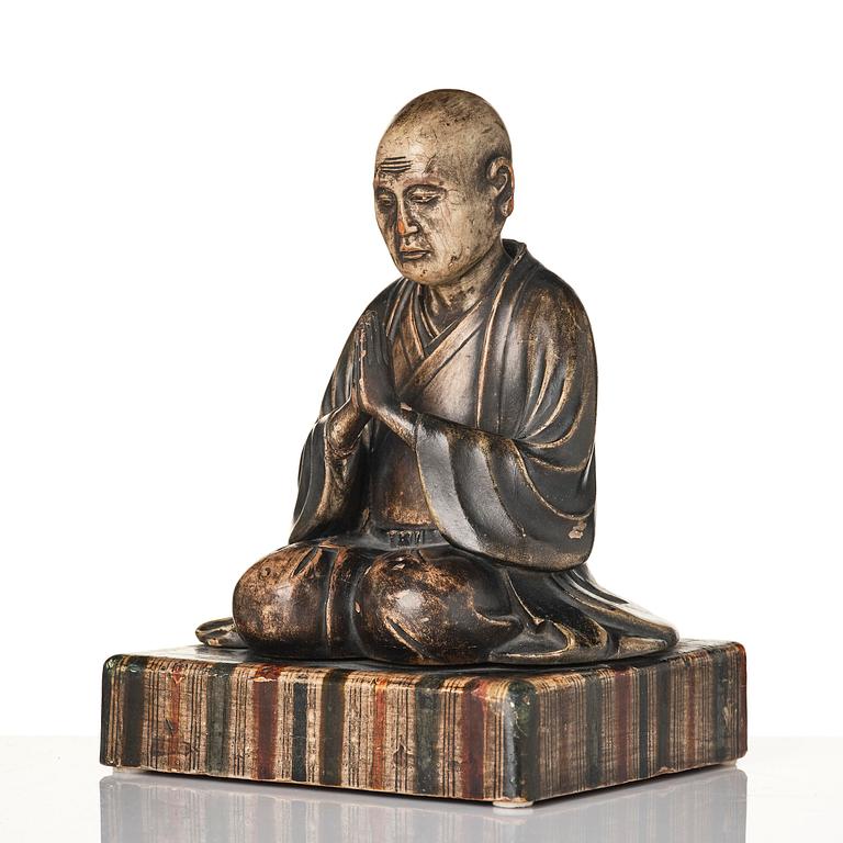 A painted and lacquered wooden sculpture of a monk, Japan, 19th century.