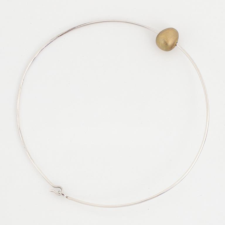 Gunilla Lantz, silver and gilded egg necklace.