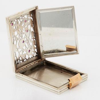 A Boucheron vanity case in silver set with faceted rubies.