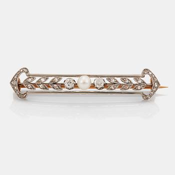 950. A 14K gold and platinum brooch set with a pearl and old- and rose-cut diamonds.