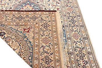A Nain carpet, part silk, 9 laa, c. 300 x 195 cm.