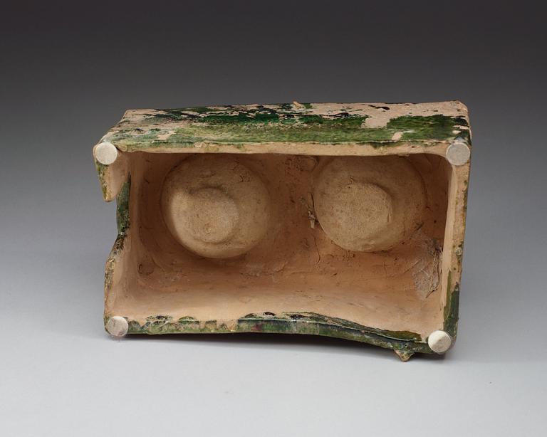 A green glazed pottery model of a stove, Han dynasty  (206 BC– AD 220).