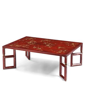 1008. A Chinese red low table, 20th century.