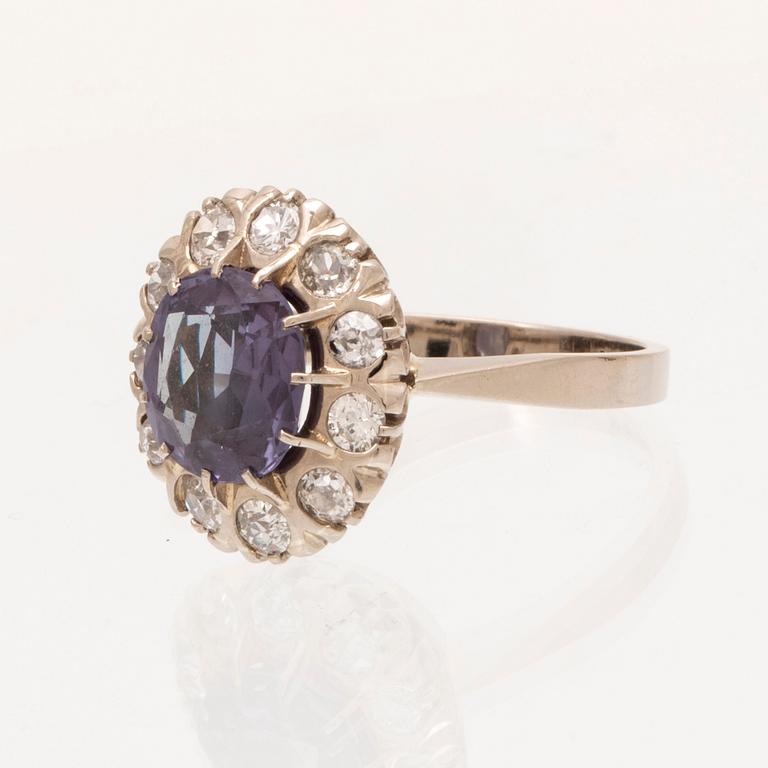 An 18K white gold ring with a colour change synthetic purple sapphire and brilliant and old cut diamonds.