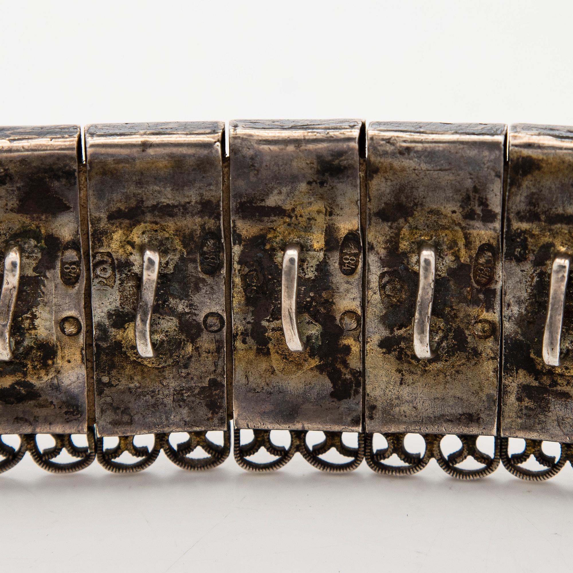 A Caucasian parcel-gilt costume belt with niello decor, 1908-26.