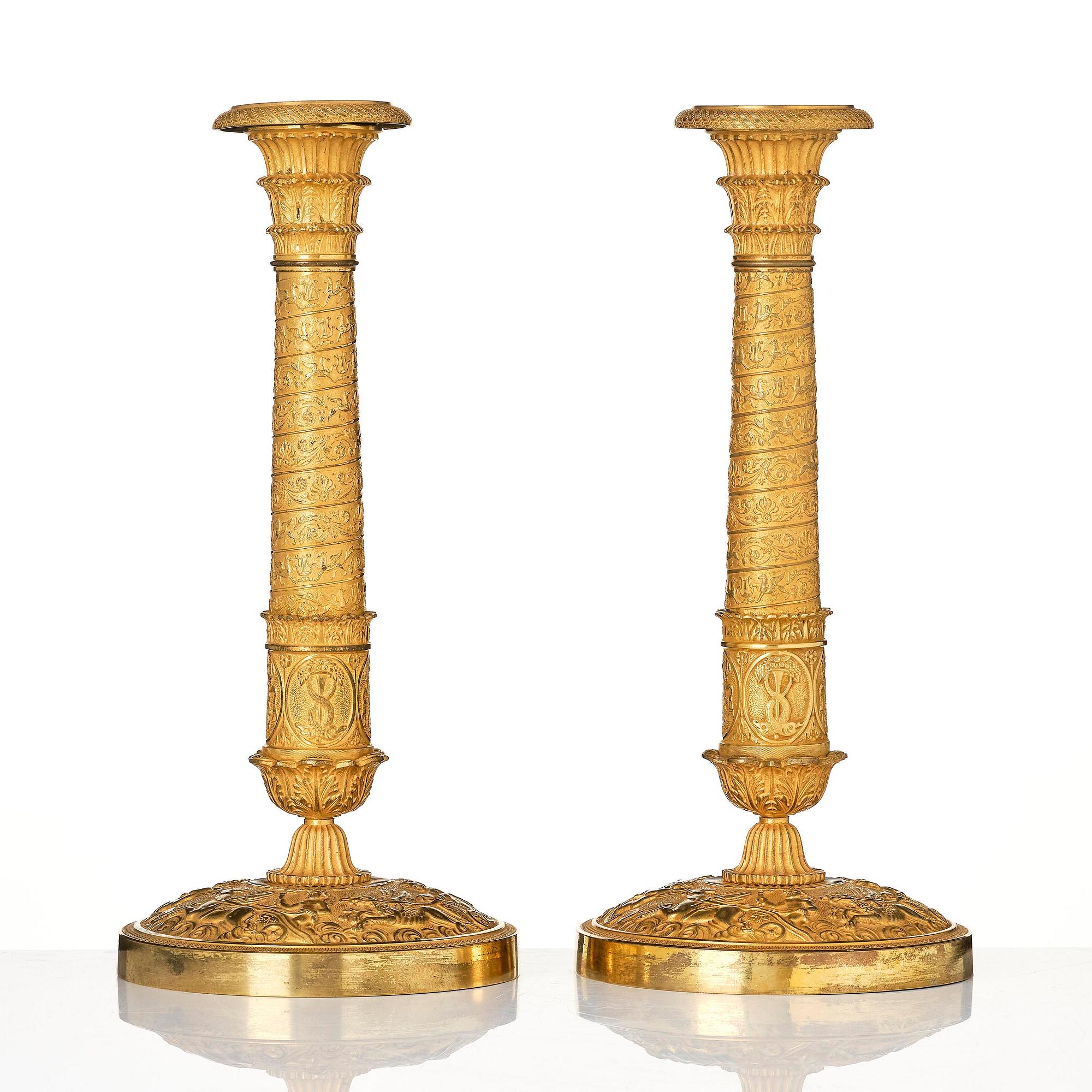 A pair of French Empire ormolu candlesticks, Paris, early 19th century.
