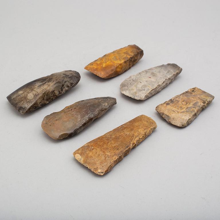 Six neolithic flint axes.