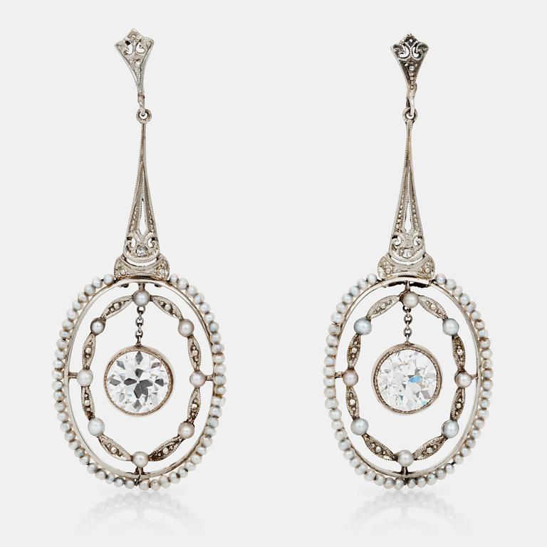A pair of seed-pearl and diamond earrings. Total diamond weight circa 2.50 cts.