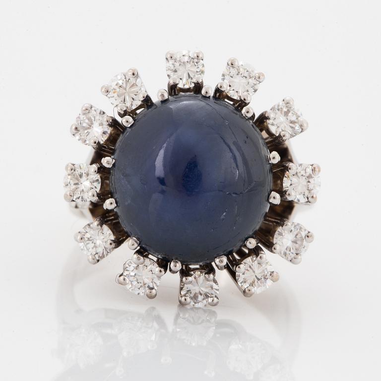 Cabochon-cut sapphire and brilliant-cut diamond cocktail ring.