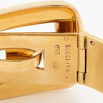 A Gucci bracelet 18K gold with blue enamel.