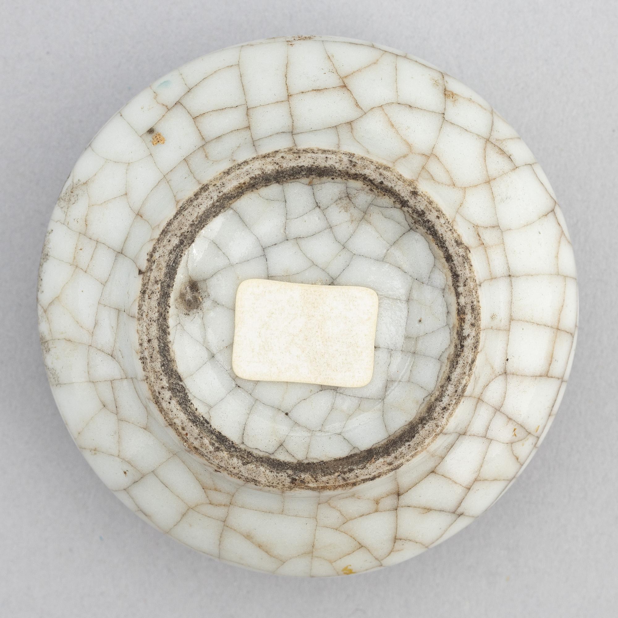 A Chinese celadon glazed lotus leaf shaped bowl, late Qing dynasty, and a ge-glazed brush washer, possibly 20 century.