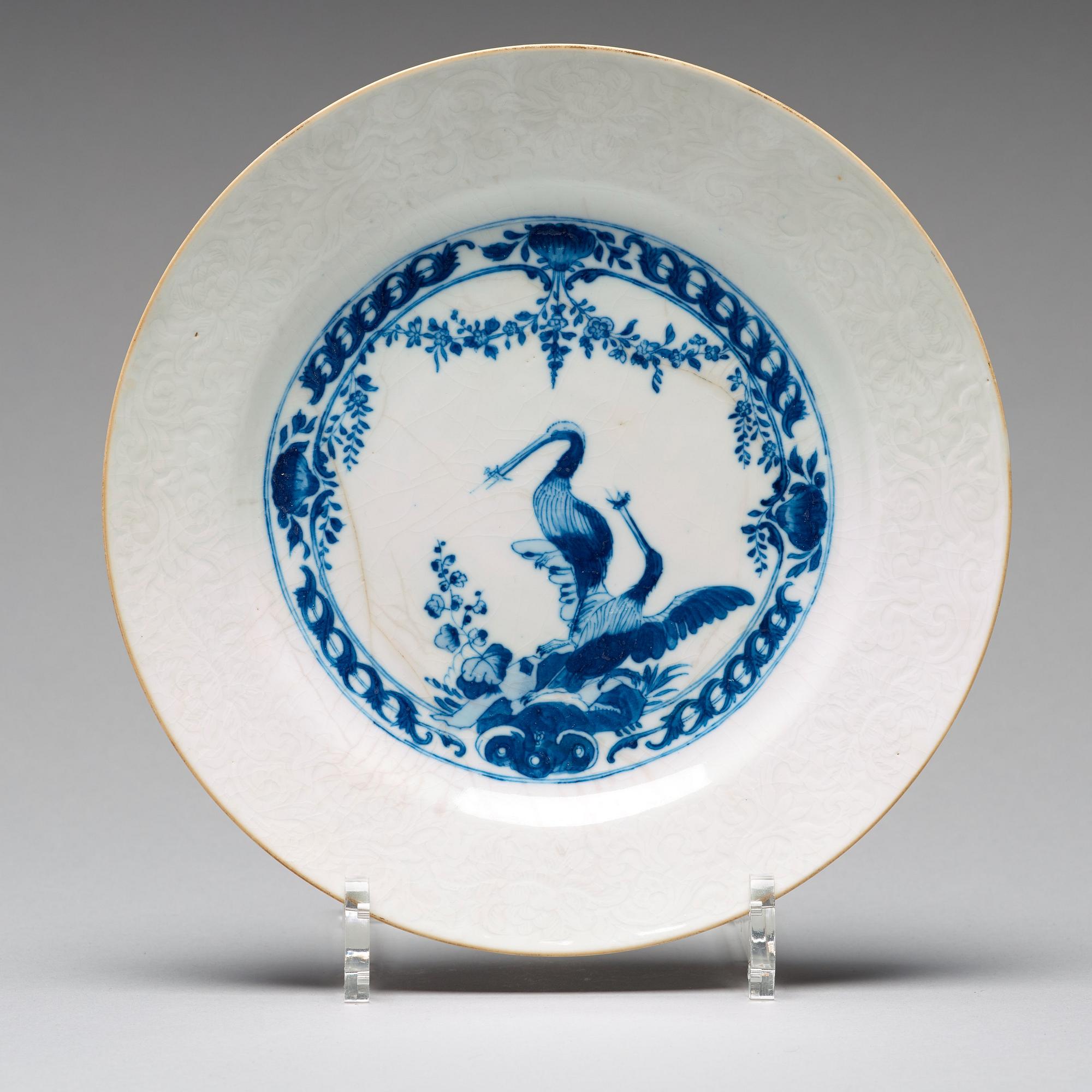 A set of four blue and white armorial dinner plates, Qing dynasty, 18th Century.