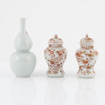 A pair of Kangxi urns, China, early 18th century, and a gourd-shaped vase, China, late 19th century.