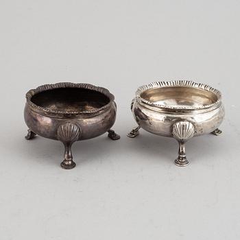 Two pairs of English 18th century silver salt-cellars, marked in London 1762 and 1769.