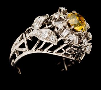 A white gold and brownyellow diamond ring.