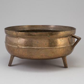 A 19th century brass cauldron.