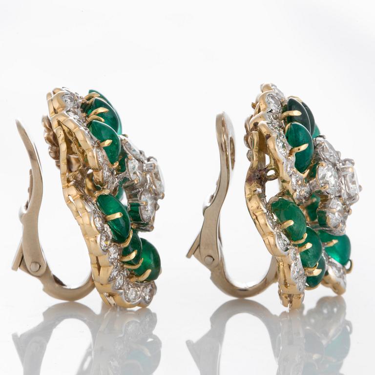 A pair of Bulgari earrings set with cabochon-cut emeralds and round brilliant-cut diamonds.