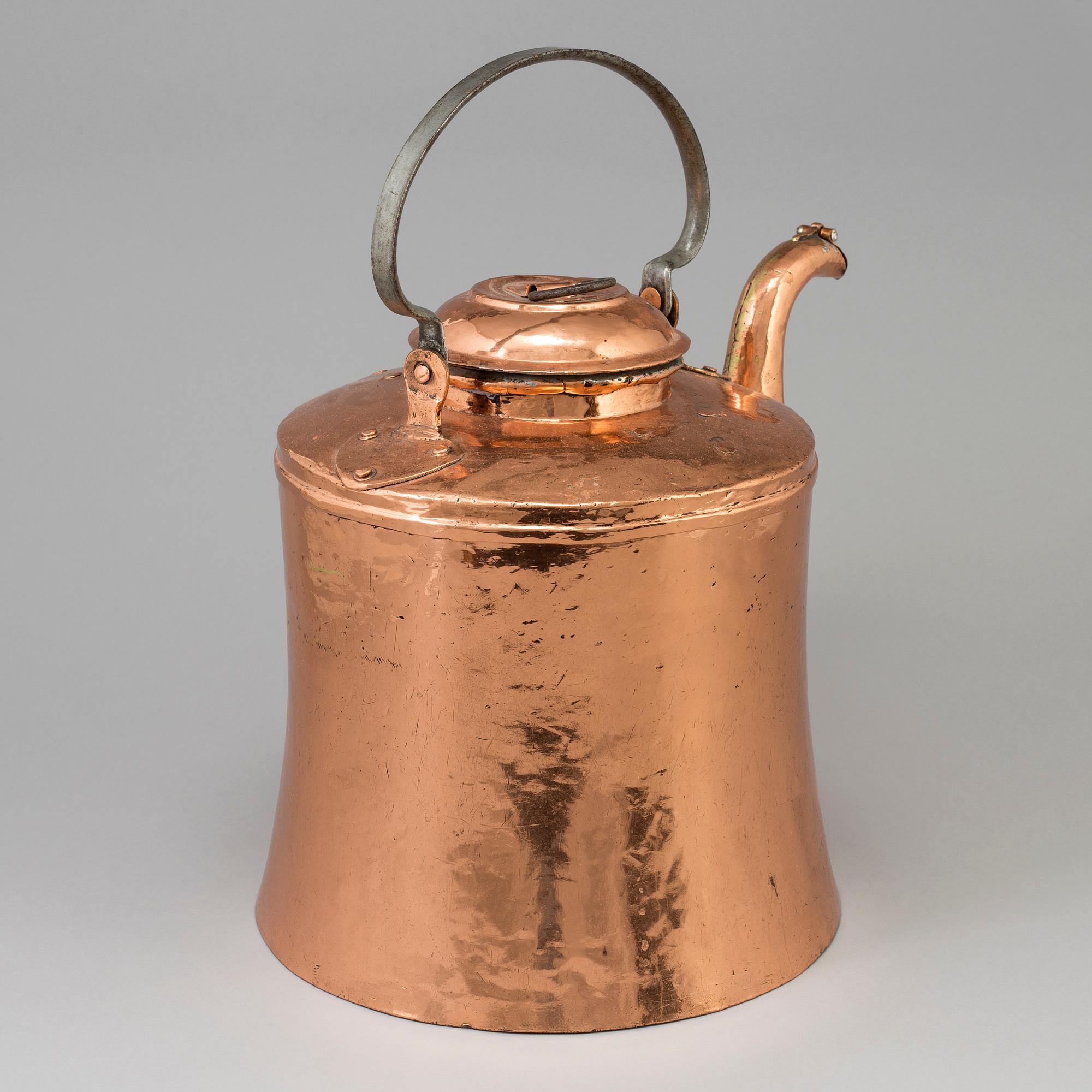 A 19th century copper pot with lid and handle.