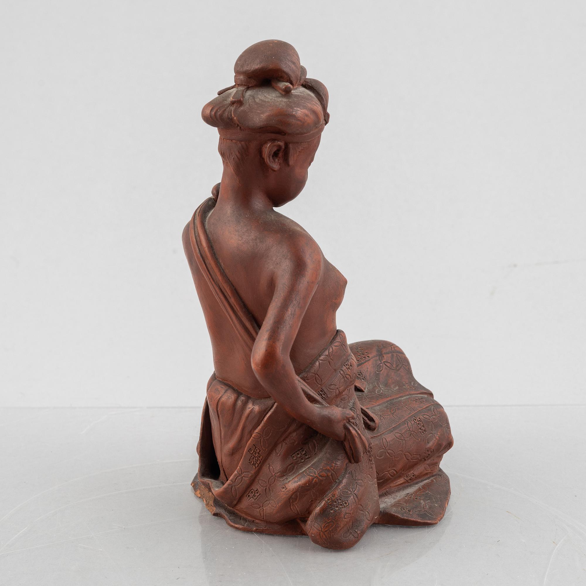 A pottery figure of a seated woman, Japan, Taisho period (1912-26), signed Sais.