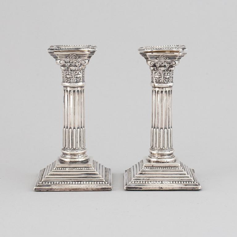 A pair of silver candle sticks, England.