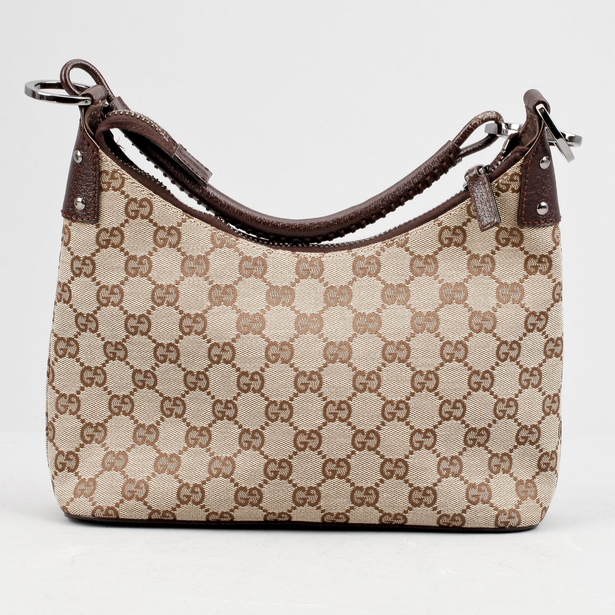 GUCCI, a beige monogram canvas shoulderhandbag.