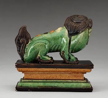 A green, yellow and aubergine glazed figure of a dog, Qing dynasty, 19th Century.
