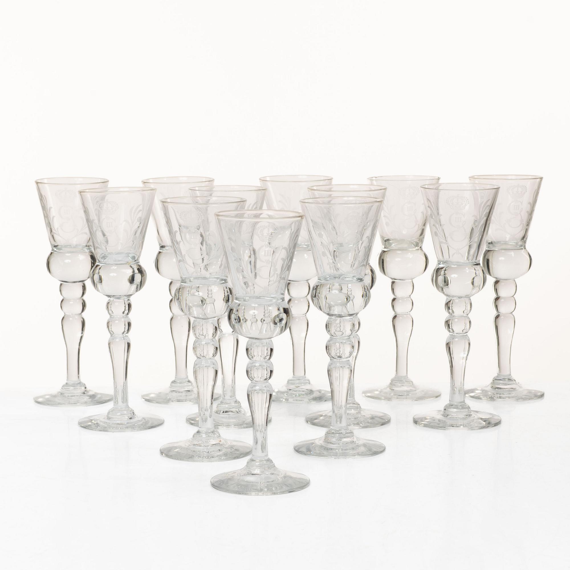 A set of 12 schnaps glasses by Reijmyre Glassworks with king Gustav III emblem.