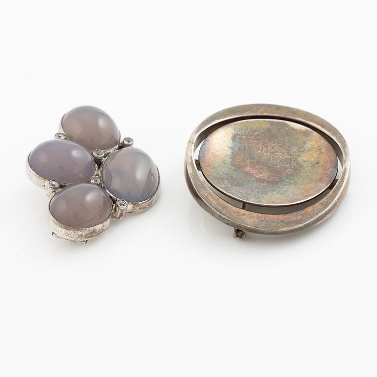 Two brooches, silver with chalcedony and white stones, SE Högberg, Gothenburg 1964 and H Strömdahl, Stockholm.