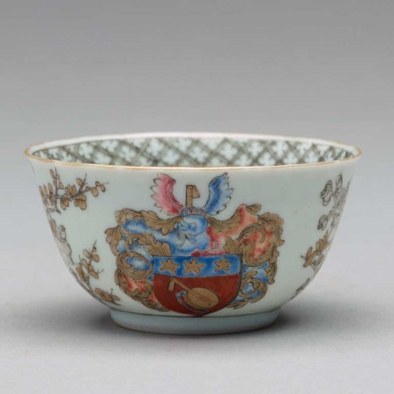 A famille rose armorial cup with saucer, Qing dynasty, 18th Century.