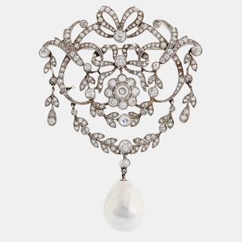 413. A platinum brooch set with old-cut diamonds and with a drop shaped pearl.