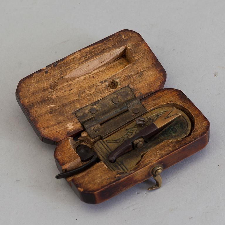 A brass and iron phleam dated 19th century.